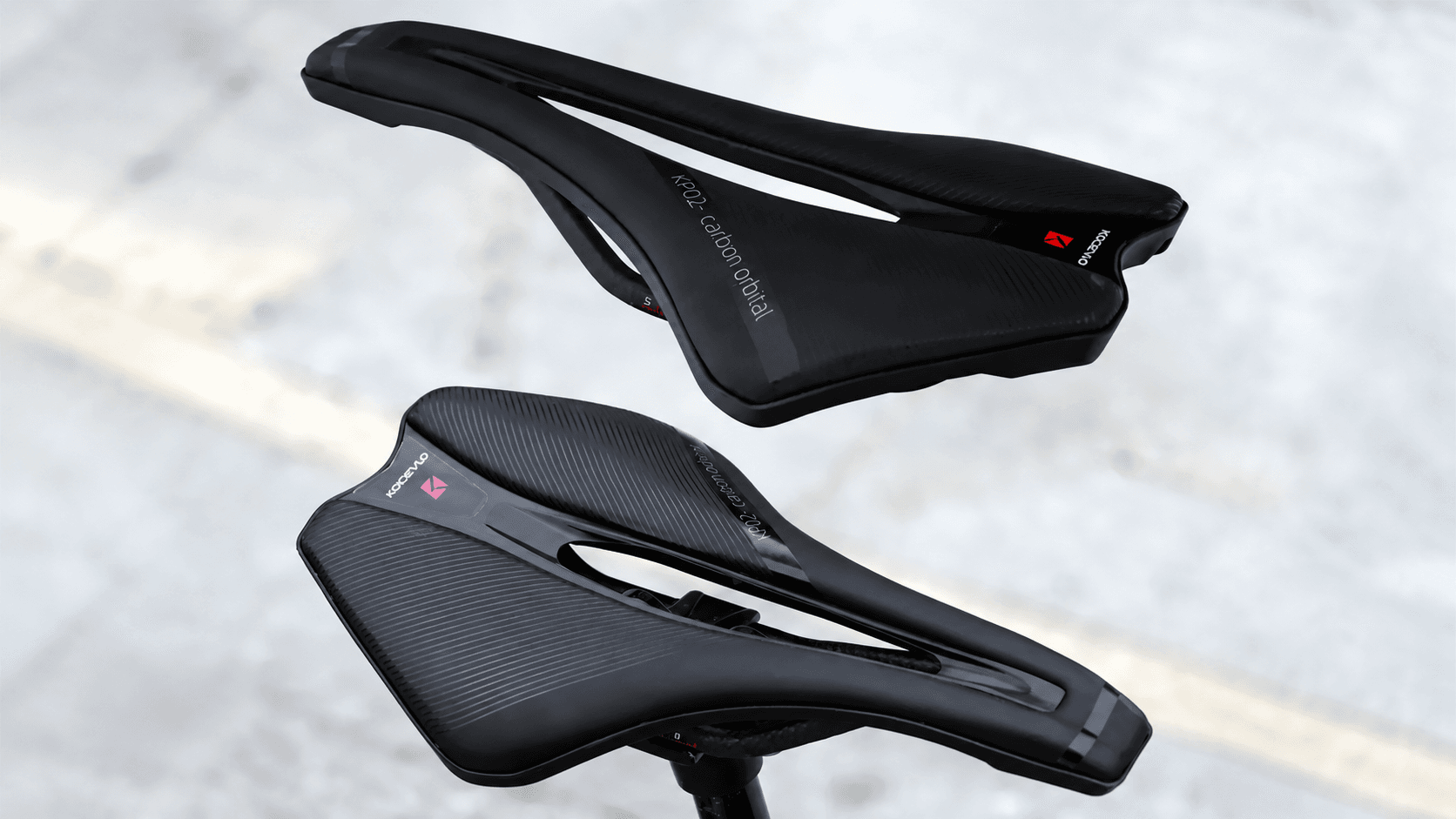 Two KOCEVLO lightweight carbon orbital bike saddles overhead multi-angle shot, black streamlined hollow cycling seat for gravel road bicycle